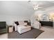Bright bonus room featuring neutral carpeting, comfortable seating arrangement, and a modern ceiling fan at 800 Heyward Cove Pl, Charleston, SC 29412