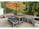 Charming outdoor space with a wooden deck, bench seating and a large umbrella, ideal for enjoying the outdoors at 800 Heyward Cove Pl, Charleston, SC 29412