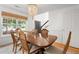 Bright dining room with classic chandelier, wainscoting, and natural light, perfect for gatherings at 800 Heyward Cove Pl, Charleston, SC 29412