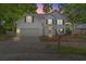 Charming two-story home featuring manicured front lawn at dusk, with inviting curb appeal at 800 Heyward Cove Pl, Charleston, SC 29412