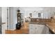 Open kitchen with hardwood floors, neutral tones, and seamless flow into the living area at 800 Heyward Cove Pl, Charleston, SC 29412