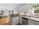 Bright kitchen with hardwood floors, white cabinets, stainless steel appliances, and views of the living area at 800 Heyward Cove Pl, Charleston, SC 29412
