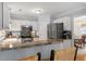 Charming kitchen featuring white cabinets, stainless steel appliances, and a cozy breakfast bar at 800 Heyward Cove Pl, Charleston, SC 29412