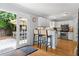 Cozy kitchen with hardwood floors, white cabinetry, and access to an outdoor seating area at 800 Heyward Cove Pl, Charleston, SC 29412