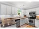 Well-lit kitchen with stainless steel appliances, light cabinets, and light countertop, offering functionality at 800 Heyward Cove Pl, Charleston, SC 29412