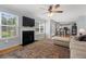 Open-concept living room with hardwood floors, fireplace, and seamless access to the kitchen at 800 Heyward Cove Pl, Charleston, SC 29412