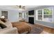 Comfortable living room with hardwood floors, fireplace, and abundant natural light at 800 Heyward Cove Pl, Charleston, SC 29412