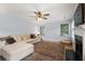 Inviting living room with a fireplace, plush seating, and ample natural light at 800 Heyward Cove Pl, Charleston, SC 29412