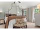 Serene main bedroom with vaulted ceiling, a four-poster bed, and natural light at 800 Heyward Cove Pl, Charleston, SC 29412
