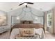 Cozy main bedroom featuring a four-poster bed, soft lighting, and soothing decor creating a peaceful retreat at 800 Heyward Cove Pl, Charleston, SC 29412
