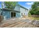 The back of the blue house has a back deck with a wooden fence surrounding the lush yard at 8112 Halifax Way, North Charleston, SC 29420