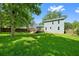 Large backyard with mature trees, a spacious lawn, and a wooden deck at 8112 Halifax Way, North Charleston, SC 29420