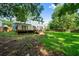 A luscious green yard backs up to a blue house with a wooden deck that leads to the back door at 8112 Halifax Way, North Charleston, SC 29420