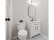 Modern bathroom with white vanity, oval mirror, and patterned tile flooring at 8112 Halifax Way, North Charleston, SC 29420