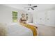 Bright bedroom features a ceiling fan, neutral colors, and natural light from large windows at 8112 Halifax Way, North Charleston, SC 29420