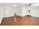 Open concept bonus room with fan and wood flooring with stairs to another room at 8112 Halifax Way, North Charleston, SC 29420