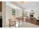 Bright breakfast area with a round table and natural light opening to living area with fireplace at 8112 Halifax Way, North Charleston, SC 29420