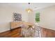 Bright dining room with hardwood floors, modern light fixture, and stylish furniture at 8112 Halifax Way, North Charleston, SC 29420