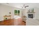 Inviting living room with a fireplace, hardwood floors, and access to the backyard deck at 8112 Halifax Way, North Charleston, SC 29420