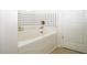 Bright bathroom featuring a white bathtub with black and white tiled accent wall at 8127 Saveur Ln, Charleston, SC 29406