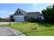 Inviting home featuring a manicured lawn, attached garage, and charming landscaping at 8127 Saveur Ln, Charleston, SC 29406