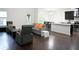 Open-concept living area featuring sleek hardwood floors and ample natural light at 8127 Saveur Ln, Charleston, SC 29406