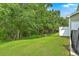 Large backyard with lush green grass and trees in the background at 9101 Parlor Dr, Ladson, SC 29456