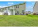 Spacious backyard featuring a lush lawn, patio area, and a view of the neighboring houses at 9101 Parlor Dr, Ladson, SC 29456