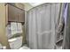 Bathroom featuring shower/tub combo with curtain, cabinet, and toilet in a neutral color scheme at 9101 Parlor Dr, Ladson, SC 29456