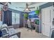 Well-lit bedroom with a comfortable seating area, ceiling fan, and large window allowing natural light to brighten the room at 9101 Parlor Dr, Ladson, SC 29456