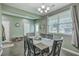 Inviting dining room featuring modern lighting, neutral paint, and a large window providing ample natural light at 9101 Parlor Dr, Ladson, SC 29456