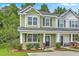 Charming two-story townhouse featuring well-maintained landscaping, a covered entrance, and inviting curb appeal at 9101 Parlor Dr, Ladson, SC 29456