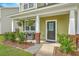 Charming front porch with seating area, beautiful landscaping, and an inviting entrance at 9101 Parlor Dr, Ladson, SC 29456
