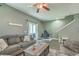 Comfortable living room featuring cozy sofas, natural light, and a ceiling fan creating a welcoming atmosphere at 9101 Parlor Dr, Ladson, SC 29456