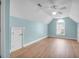 Bright bonus room with light blue walls, wood floors, a ceiling fan, and a unique arched window at 9133 Markleys Grove Blvd, Summerville, SC 29485