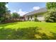 Exterior view of a home featuring a well-manicured lawn, back deck, and screened-in porch at 9133 Markleys Grove Blvd, Summerville, SC 29485