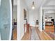 Welcoming foyer with hardwood floors, neutral walls, decorative rug, and elegant lighting fixture at 9133 Markleys Grove Blvd, Summerville, SC 29485