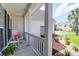 Charming porch with a rocking chair, side table, and beautiful views of the neighborhood at 9133 Markleys Grove Blvd, Summerville, SC 29485