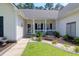 Inviting front porch with a bench, manicured landscaping, and a sidewalk leading to the entrance at 9133 Markleys Grove Blvd, Summerville, SC 29485