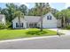 Charming single-story home with well-manicured lawn and mature palm trees at 9133 Markleys Grove Blvd, Summerville, SC 29485