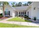 Well-maintained front yard with lush landscaping, walkway, and inviting porch at 9133 Markleys Grove Blvd, Summerville, SC 29485