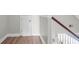 Hallway landing features light floors and a wooden railing that offers light from the first floor at 9133 Markleys Grove Blvd, Summerville, SC 29485