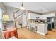 Open concept kitchen featuring white cabinets, stainless appliances, breakfast bar and adjacent living area at 9133 Markleys Grove Blvd, Summerville, SC 29485