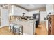 Well-lit kitchen featuring white cabinets, stainless appliances, and breakfast bar with seating at 9133 Markleys Grove Blvd, Summerville, SC 29485