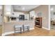Bright kitchen with white cabinets, a breakfast bar with stools, and stainless steel appliances at 9133 Markleys Grove Blvd, Summerville, SC 29485