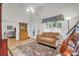 Bright living room with a plush loveseat, wood flooring, and view to another room at 9133 Markleys Grove Blvd, Summerville, SC 29485