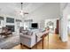 Spacious living room with vaulted ceiling, hardwood floors, fireplace, and seamless access to other rooms at 9133 Markleys Grove Blvd, Summerville, SC 29485