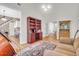 Bright living room with hardwood floors, decorative area rug, and custom shelving at 9133 Markleys Grove Blvd, Summerville, SC 29485