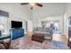 Cozy living room with hardwood floors, neutral walls, a large rug, and access to the dining room at 9133 Markleys Grove Blvd, Summerville, SC 29485