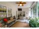 Inviting screened-in porch featuring cozy seating and a ceiling fan at 9133 Markleys Grove Blvd, Summerville, SC 29485
